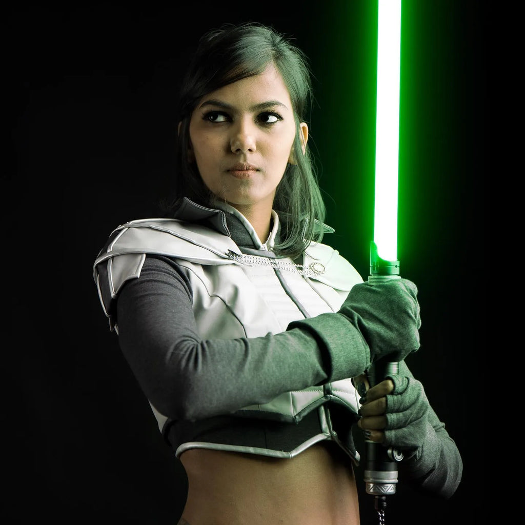 Female Jedi cosplayer holding a custom Rahm Kota-inspired neopixel lightsaber with a green blade