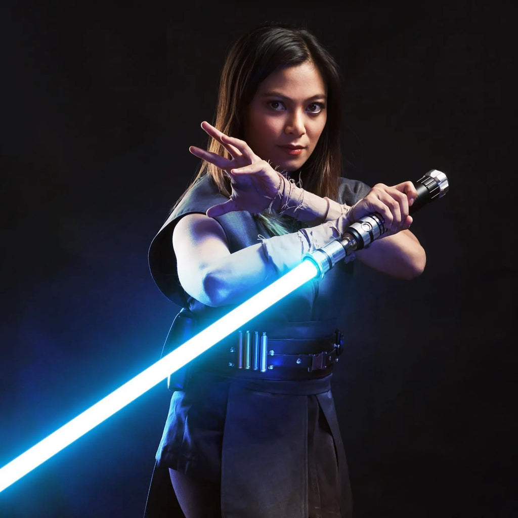 Female Jedi cosplayer holding a Luke Skywalker-inspired custom neopixel lightsaber with a blue blade