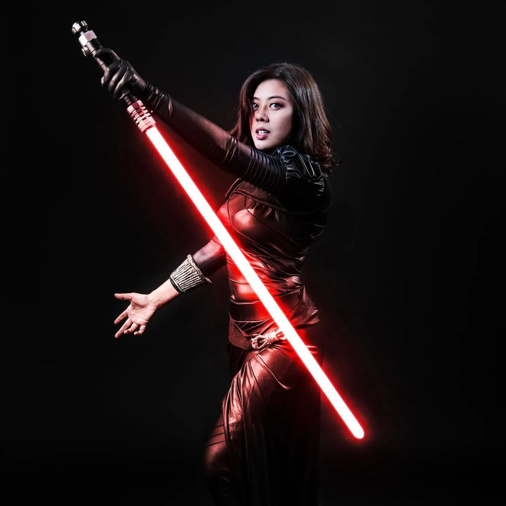 Star Wars-inspired female Sith cosplayer holding a custom neopixel lightsaber with a red blade