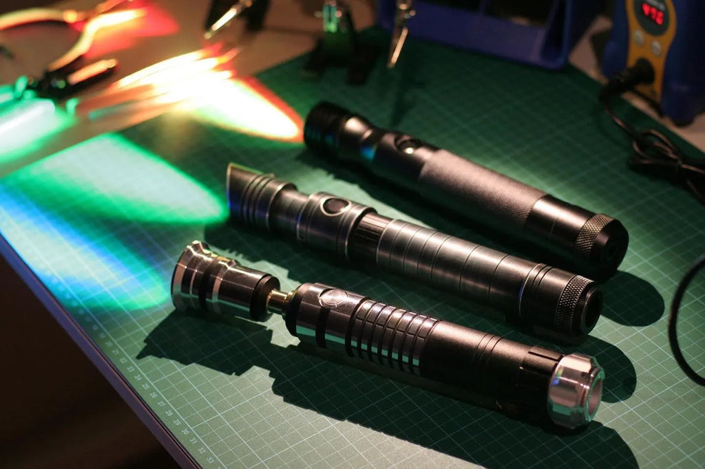 Three Star Wars-inspired custom neopixel lightsabers lying side by side