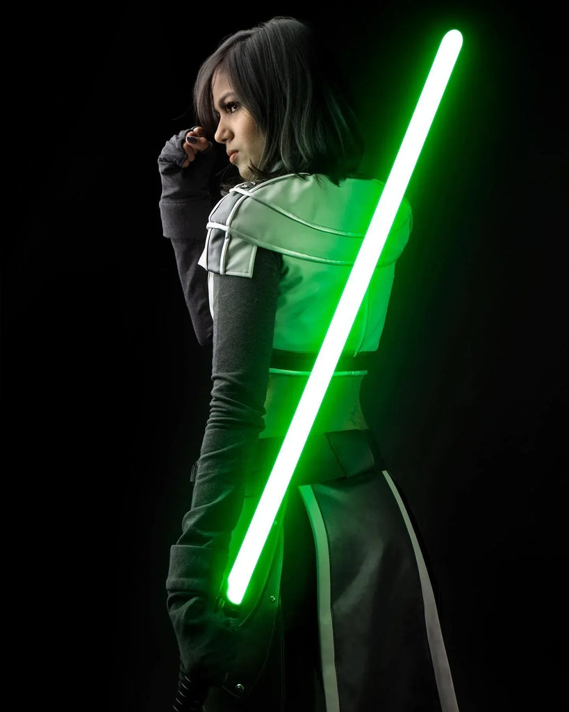 A female Jedi cosplayer holding a custom neopixel lightsaber with a green blade