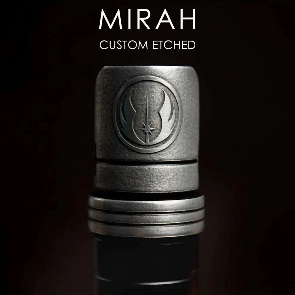 Close-up of a custom etched silver lightsaber emitter featuring the raised insignia of the Jedi Order