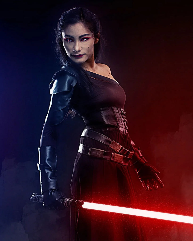 Female Sith cosplayer holding a Star Wars-inspired custom neopixel lightsaber with a red blade representing transformation