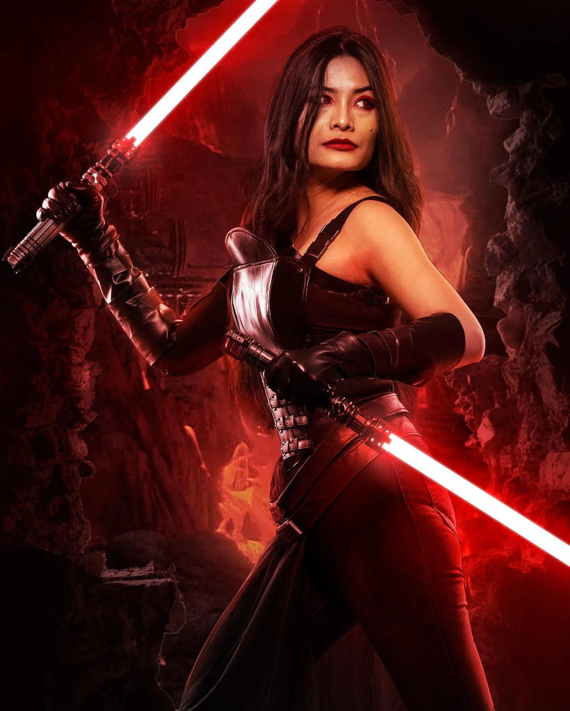 Female Sith-inspired cosplayer in a volcanic Mustafar environment with dual-wielding Sith-inspired custom neopixel lightsaber with crimson red blades