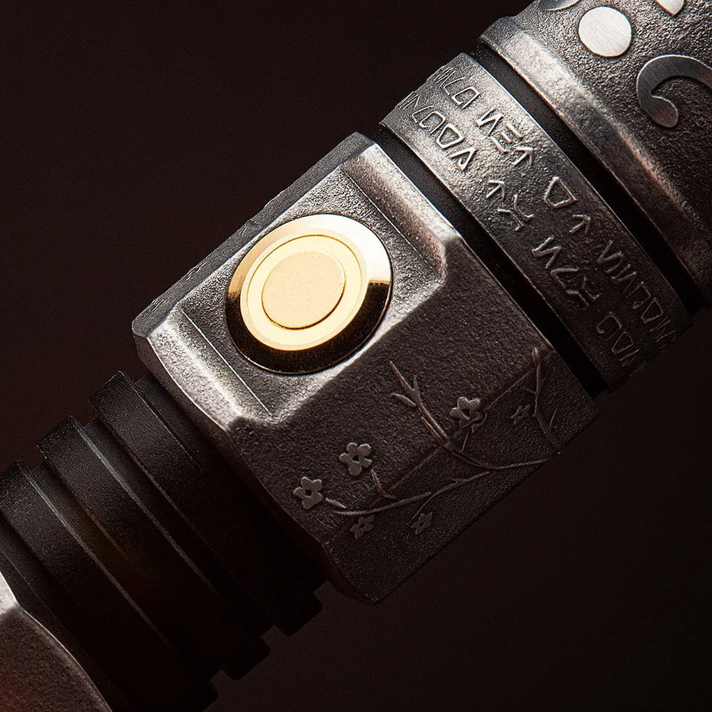 Close-up of a Star Wars-inspired custom neopixel lightsaber features cherry blossom and lotus flower etchings, framed by rings Aurebesh inscriptions