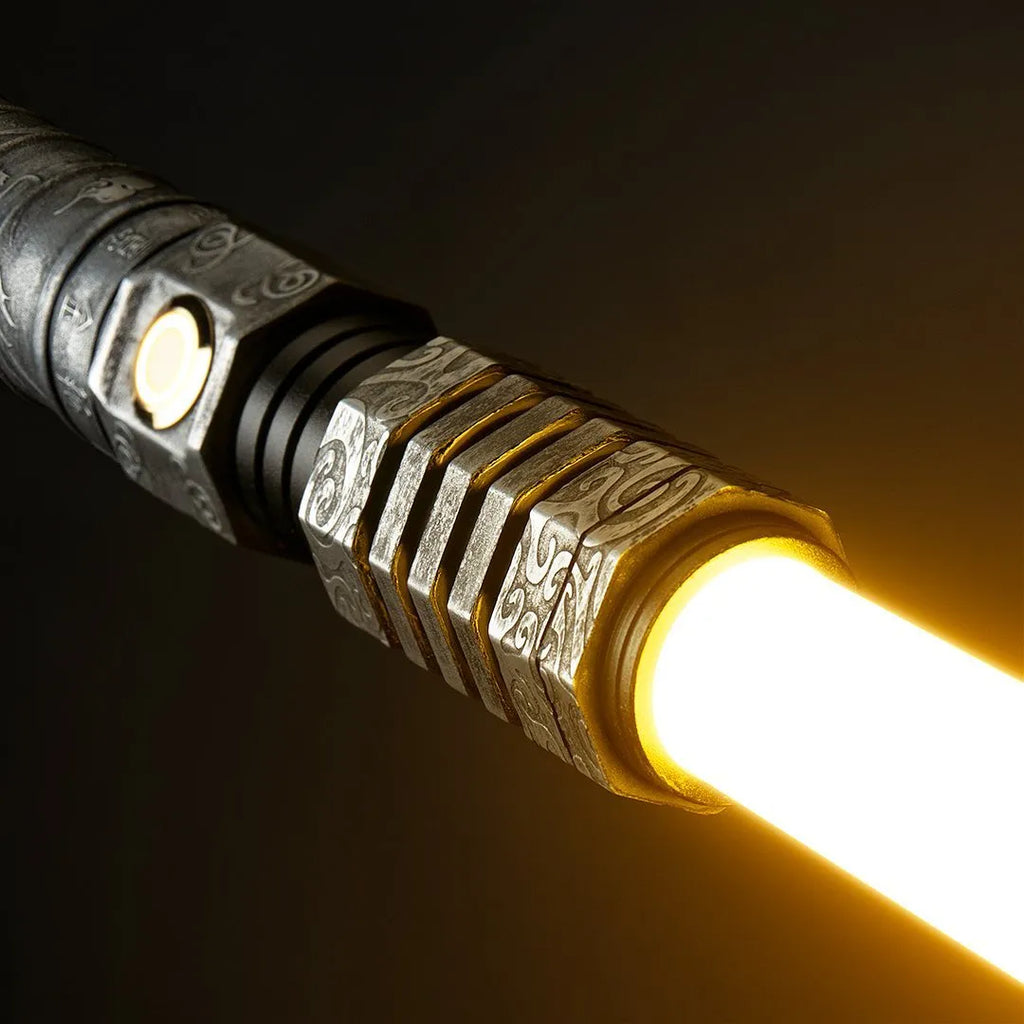 Close-up of the Star Wars-inspired custom neopixel lightsaber emitter features Sun Wukong, swirl patterns, Chinese dragon motifs with yellow blade