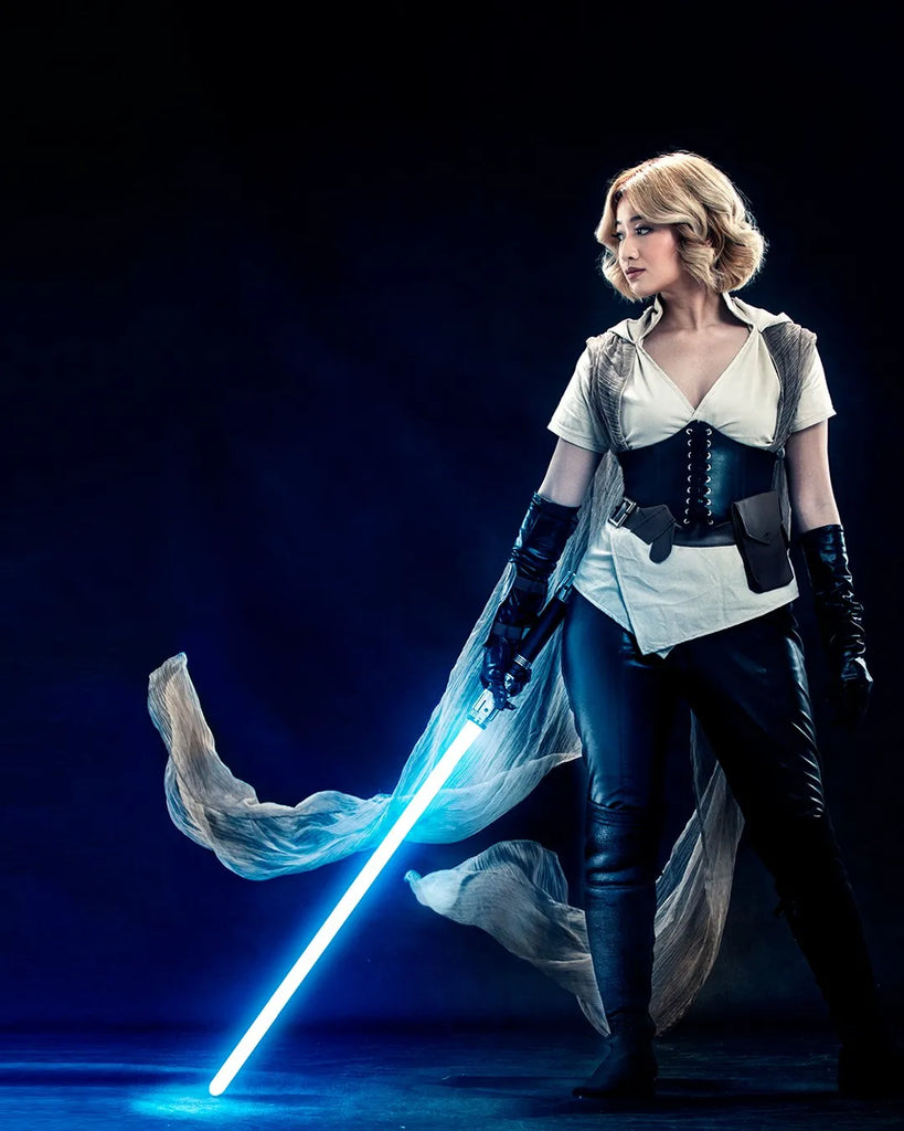 Post-Order 66 Jedi-inspired cosplayer holding a Viking-inspired custom neopixel lightsaber with bright ice blue blade