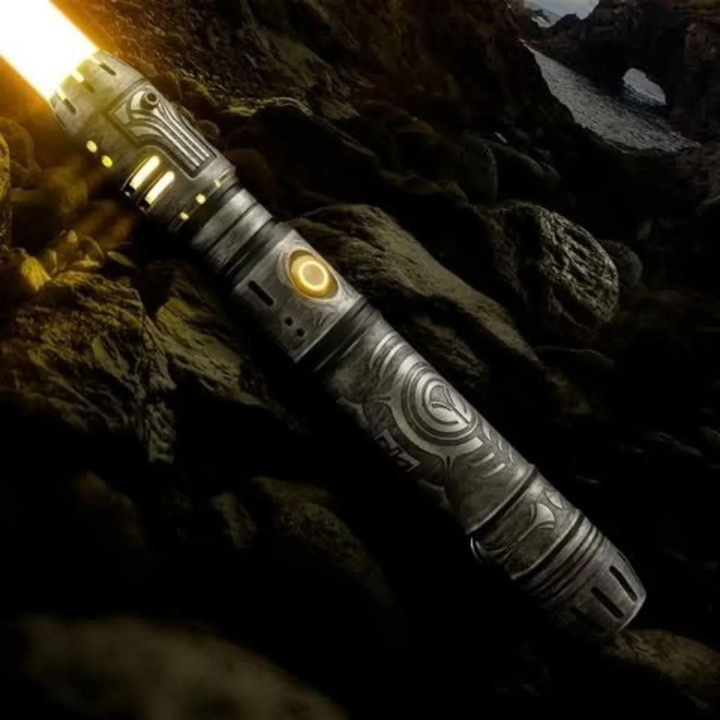 A pod racer engine-inspired custom neopixel lightsaber. The hilt features weathered finish and Zeffo-style acid etching inspired by the Tomb of Kujet
