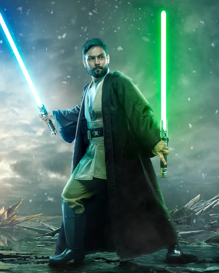 Male Jedi-inspired cosplayer dual-wielding a Ben Solo and Cal Kestis-inspired custom neopixel lightsaber with blue and green blades