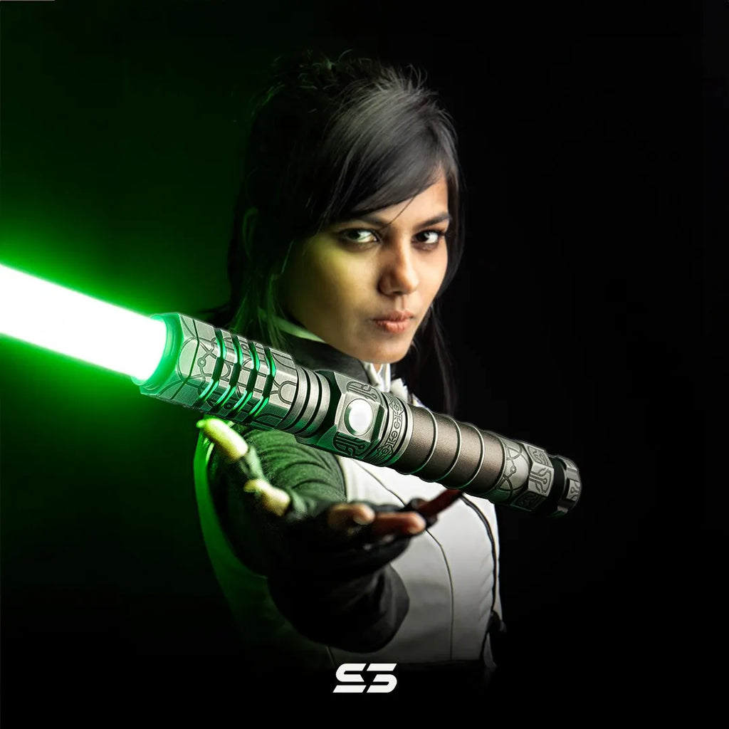Female Jedi Consular-inspired cosplayer with a Star Wars-inspired custom neopixel lightsaber, silver finish, bronze grip, acid-etched star charts